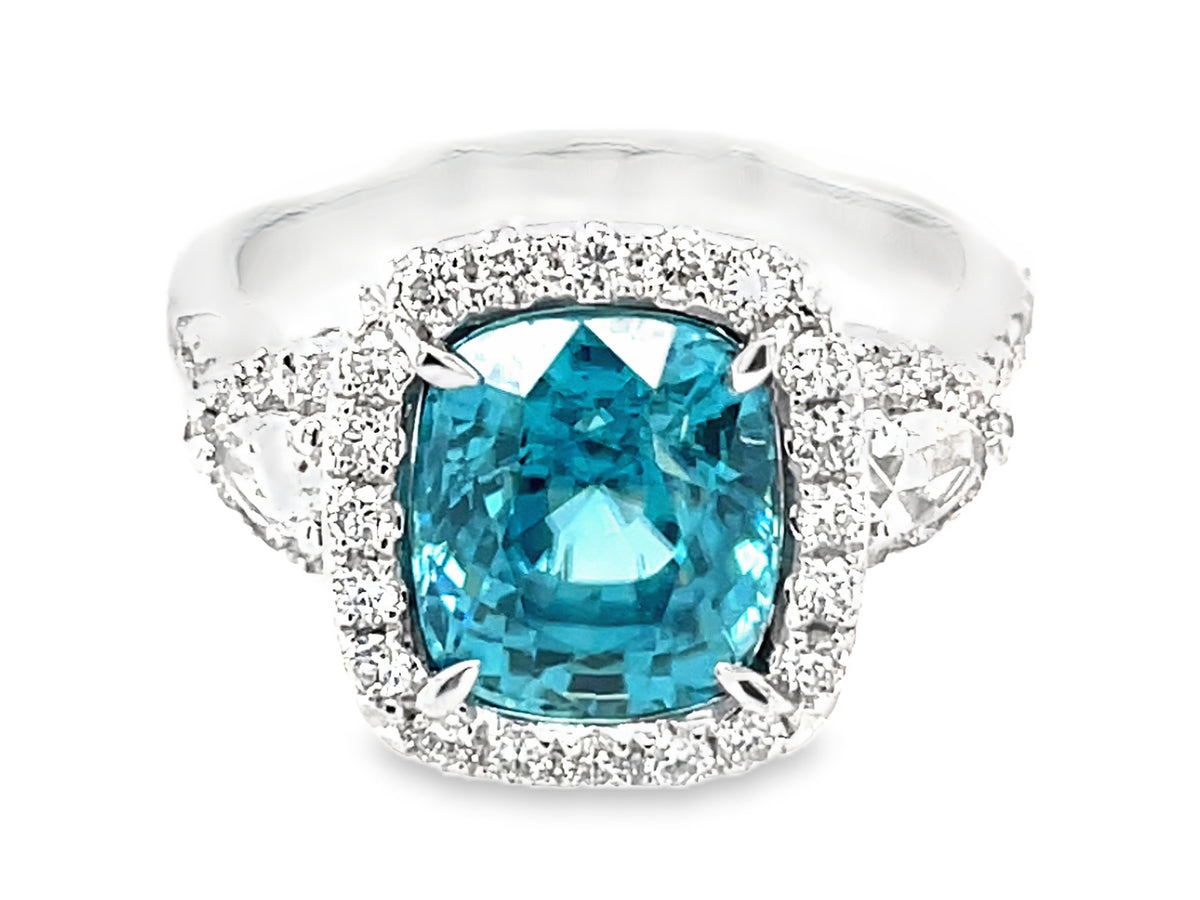 BLUE ZIRCON CUSHION & DIAMOND HALO 3 STONE RING, 18KW (H)