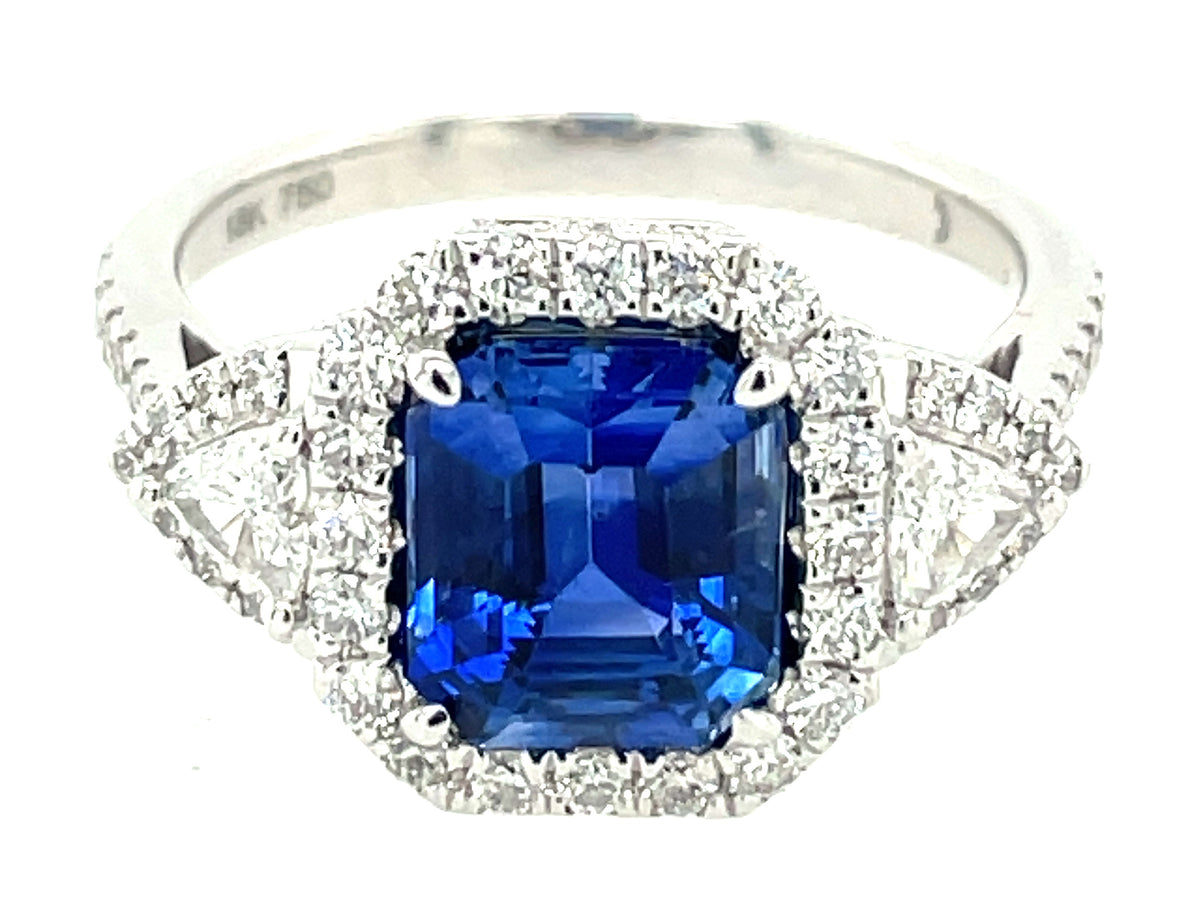SAPPHIRE EMERALD CUT & DIAMOND 3 STONE HALO RING