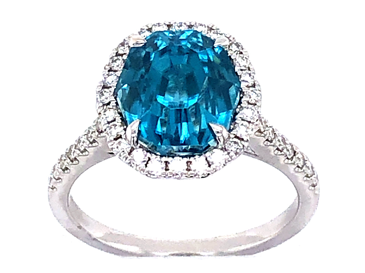 BLUE ZIRCON OVAL & DIAMOND RING, 18KW (H)